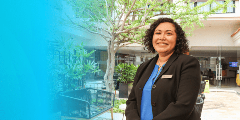 A women smiling in an office - About IDB - Inter American Development Bank - IDB